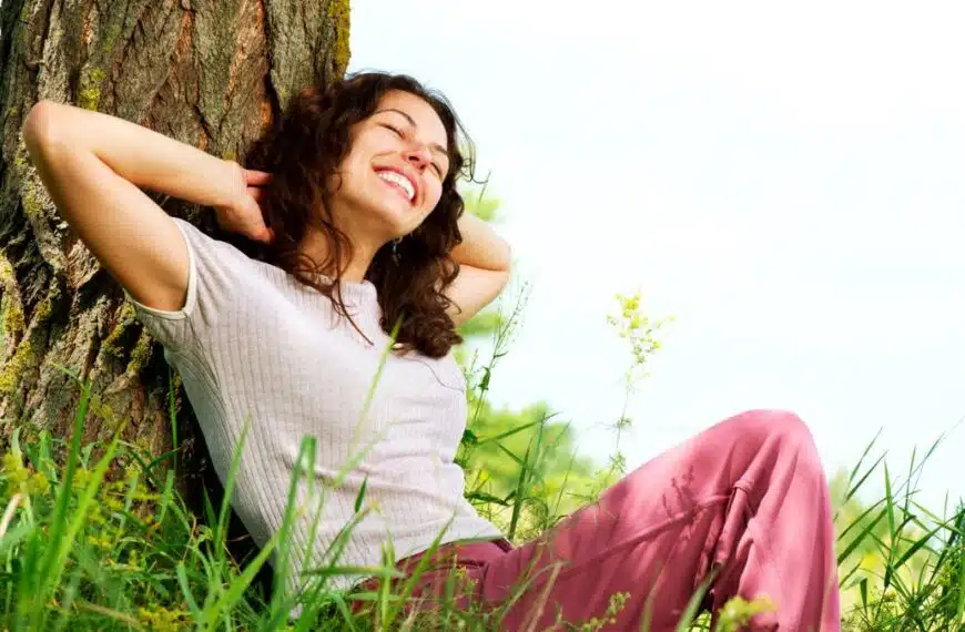 Woman smiling under a tree