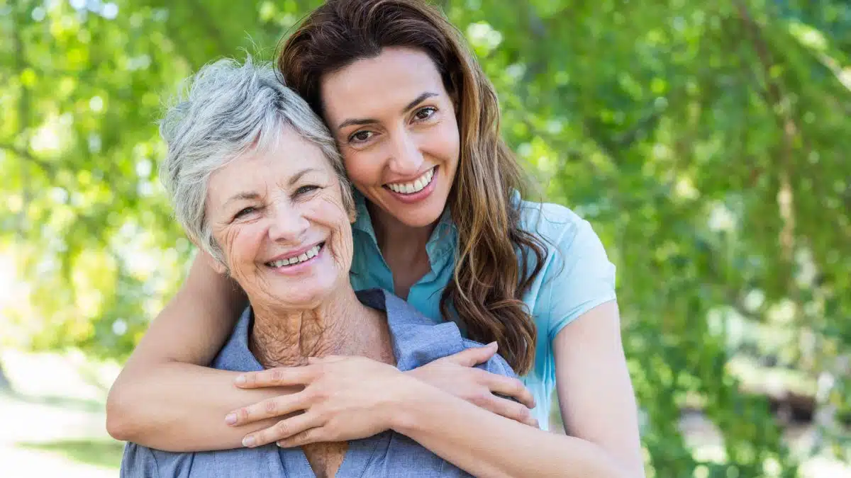 senior mother and daugther smiling