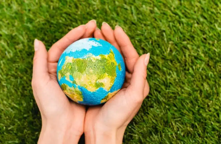 woman holding earth in grass