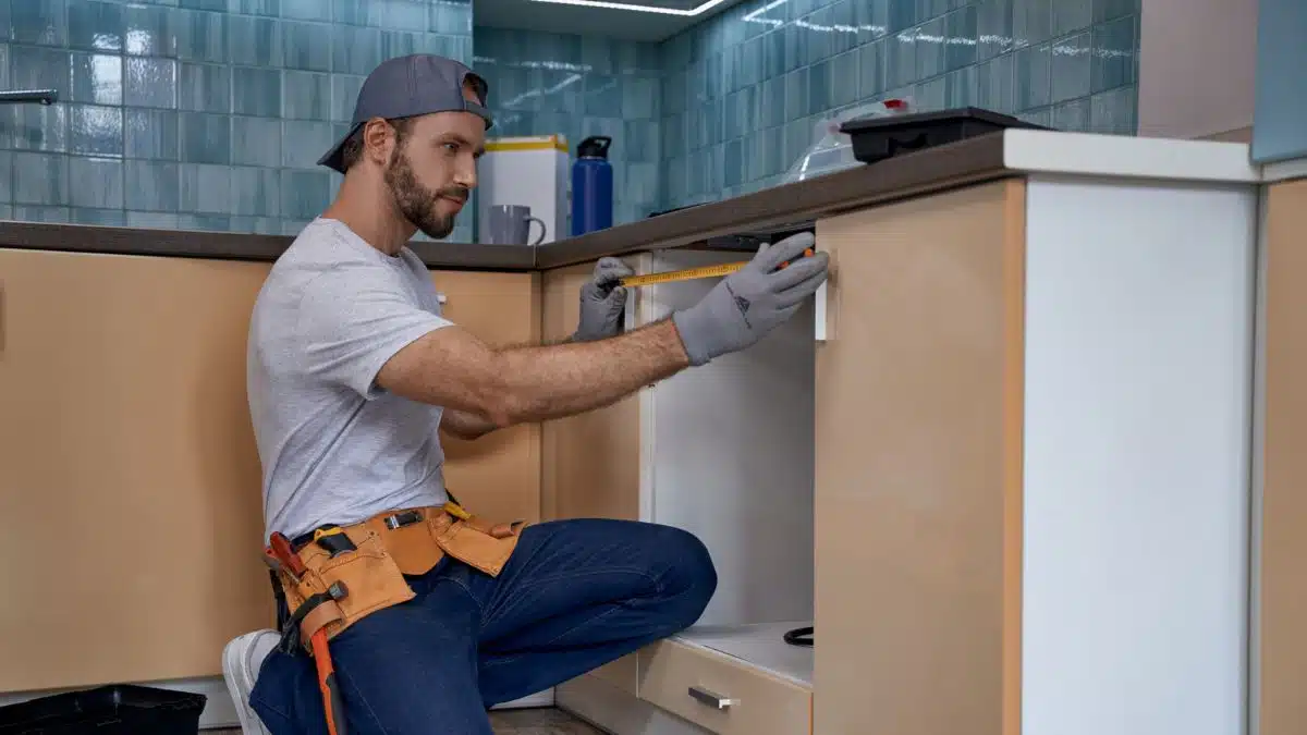 man measuring in the kitchen