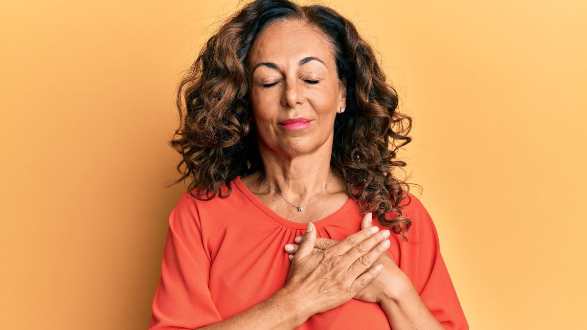 woman putting hand on heart