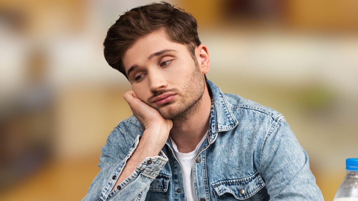 man sad eating cereal