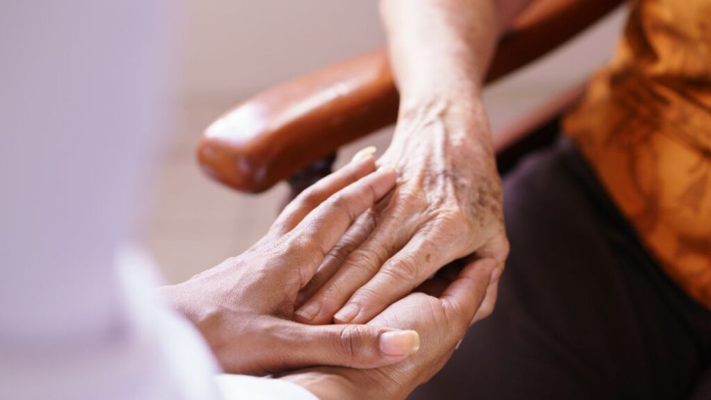 senior holding hands