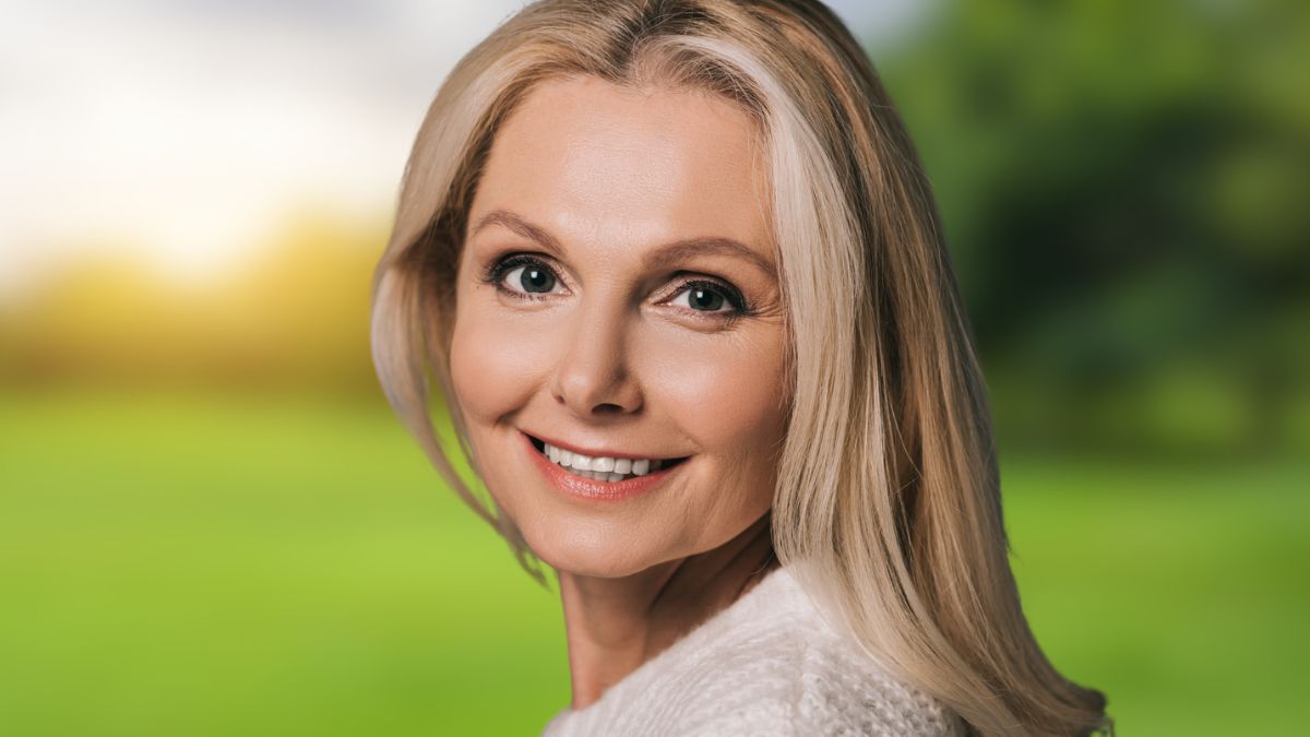 mature woman smiling in the park